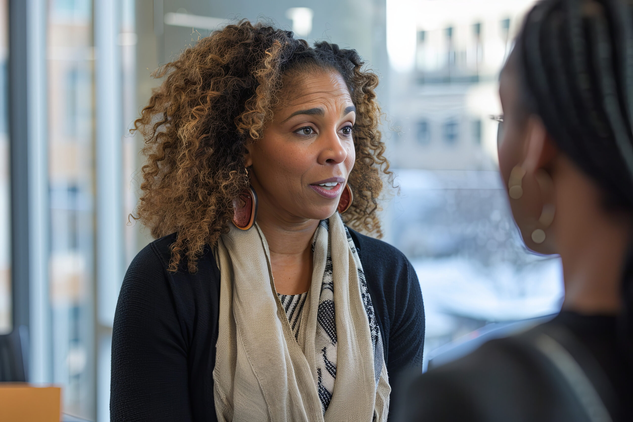 Manager attentively listening to an employee, representing empathy