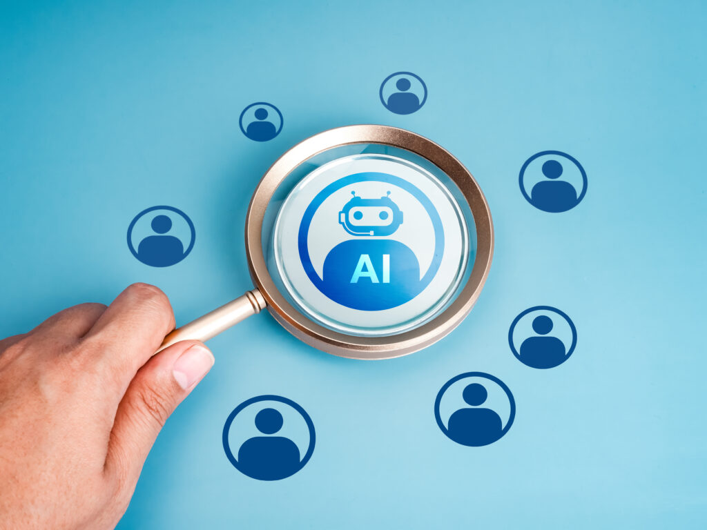 Artificial Intelligence jobs, robot career, human resource (HR), hiring, recruitment concept. AI bot icon selected by magnifying glass lens in human hand on blue background with people symbols.