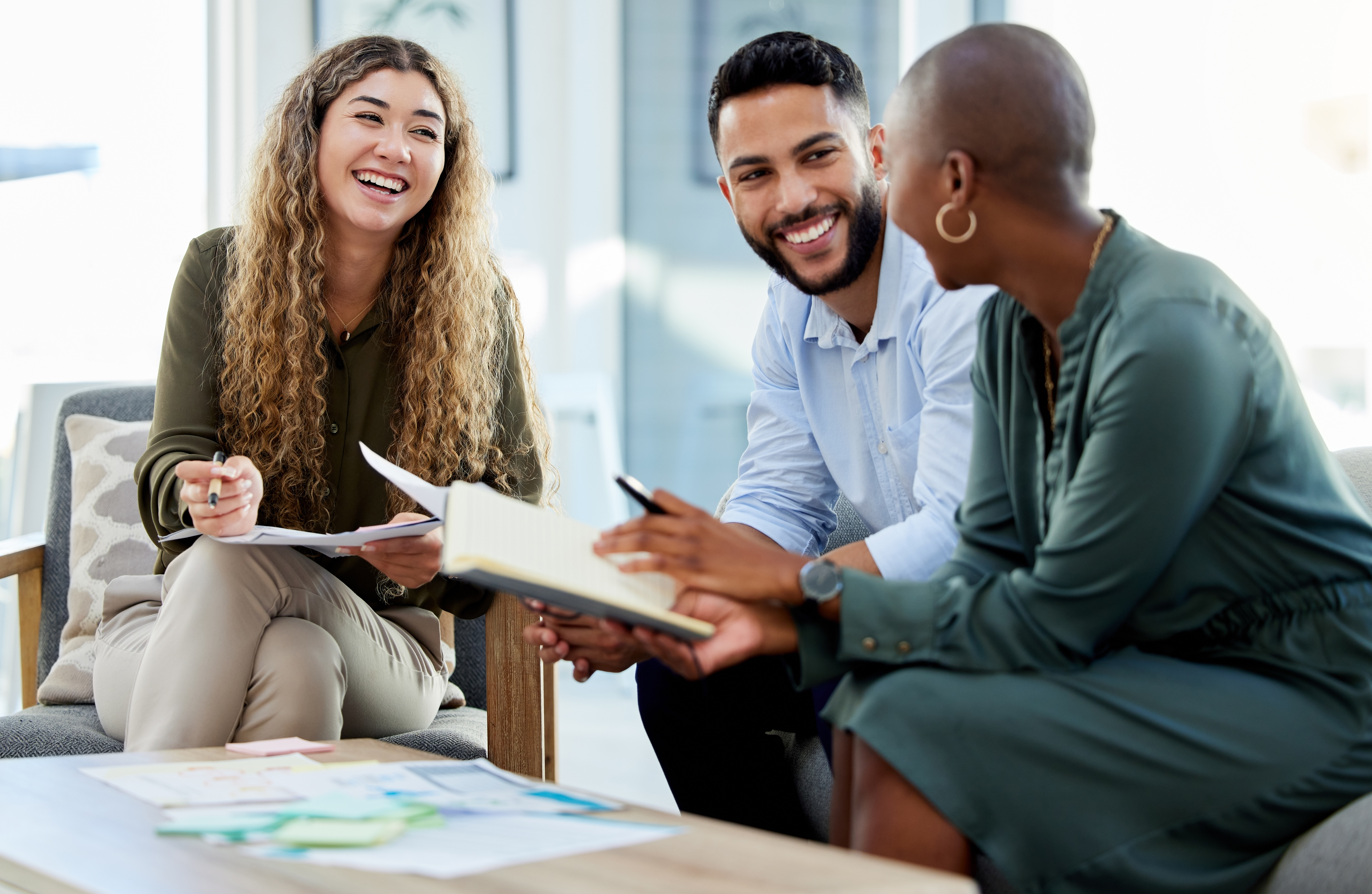 Happy business people smile during a planning meeting in a startup marketing agency office. Diversity, collaboration and teamwork in a healthy work environment in an international advertising company