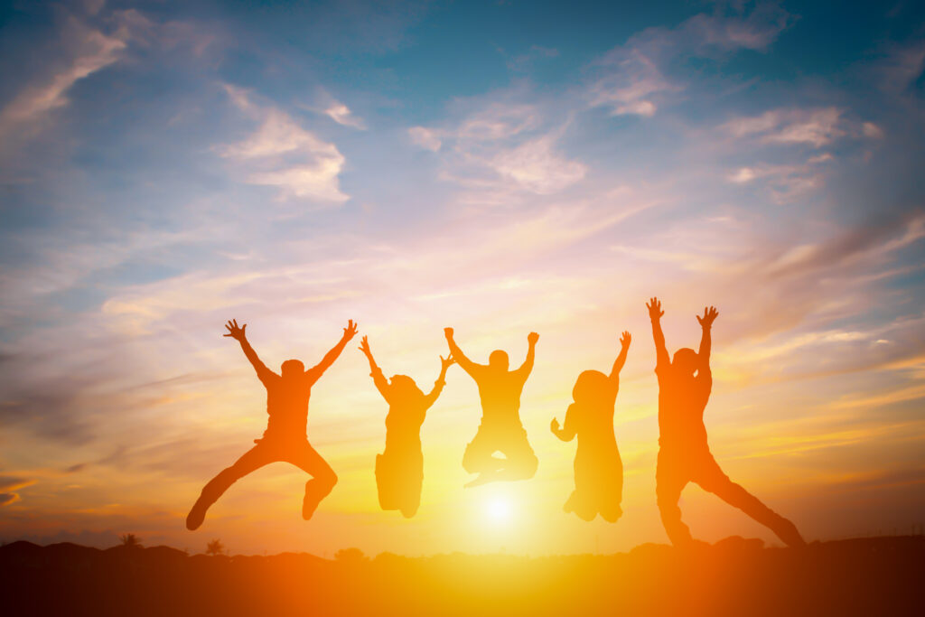 Silhouette of happy business team making high hands in sunset sky background for business teamwork concept.